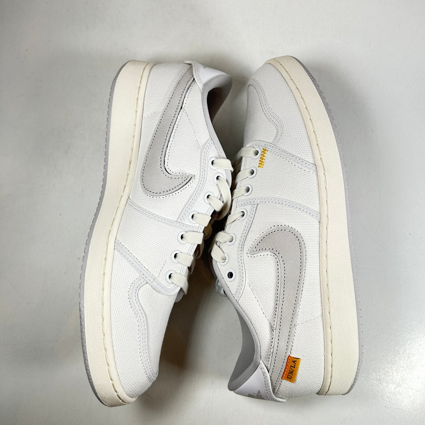 DO8912 101 Jordan 1 Retro AJKO Low SP Unión Lona Blanca